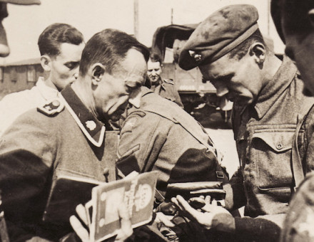 British soldiers inspect the documents of former SS guards at Bergen-Belsen concentration camp, 15 April 1943. United States Holocaust Memorial Museum.