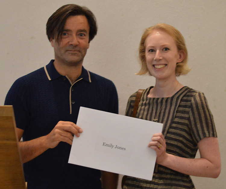 Emily Jones receives her prize from editor Paul Lay. 